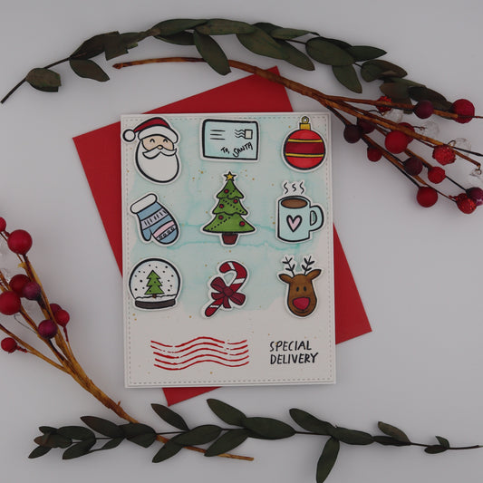Set of Christmas-themed stickers on a white card with red envelope, surrounded by decorative branches.