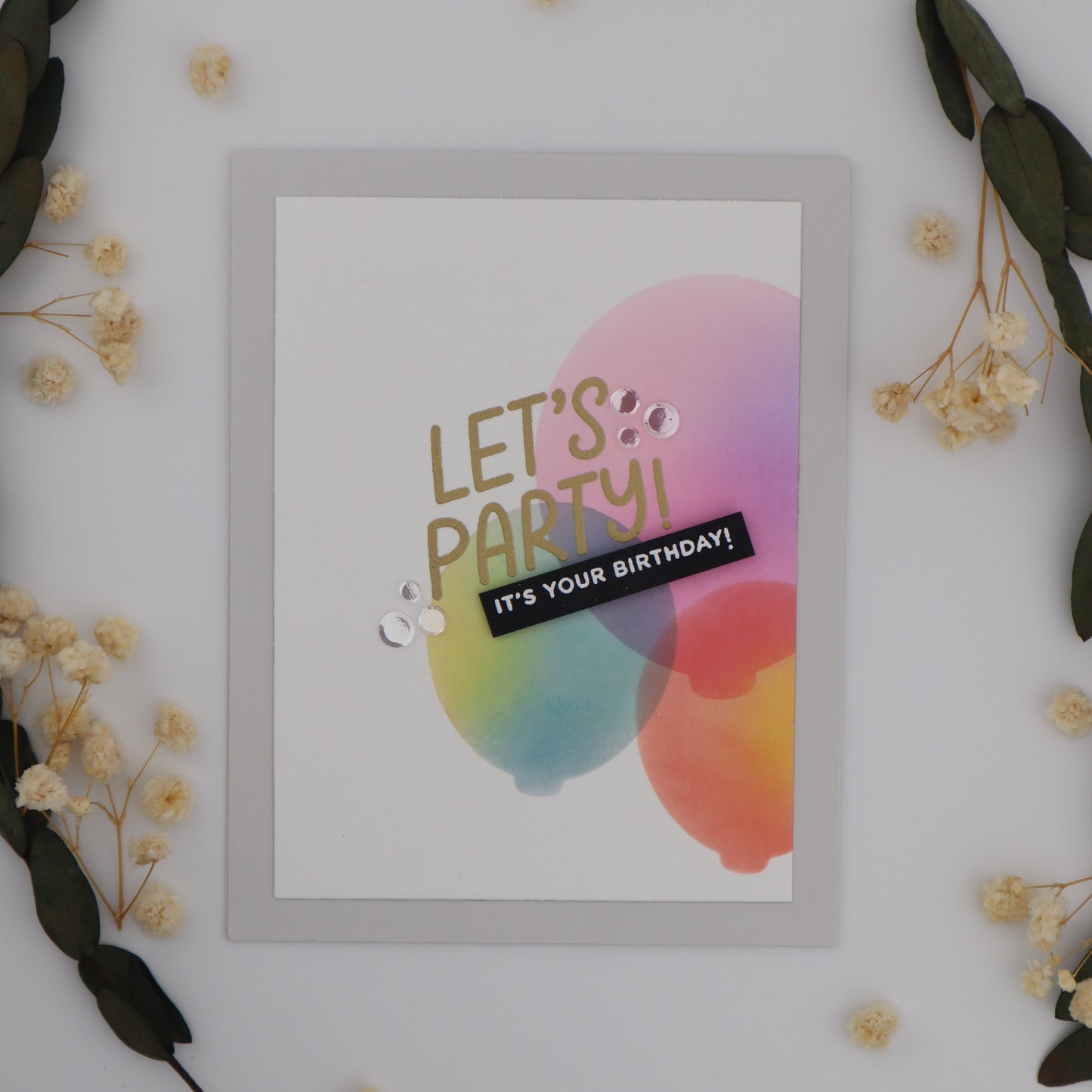 Framed poster with 'Let's Party! It's Your Birthday!' text on a white background with decorative elements.