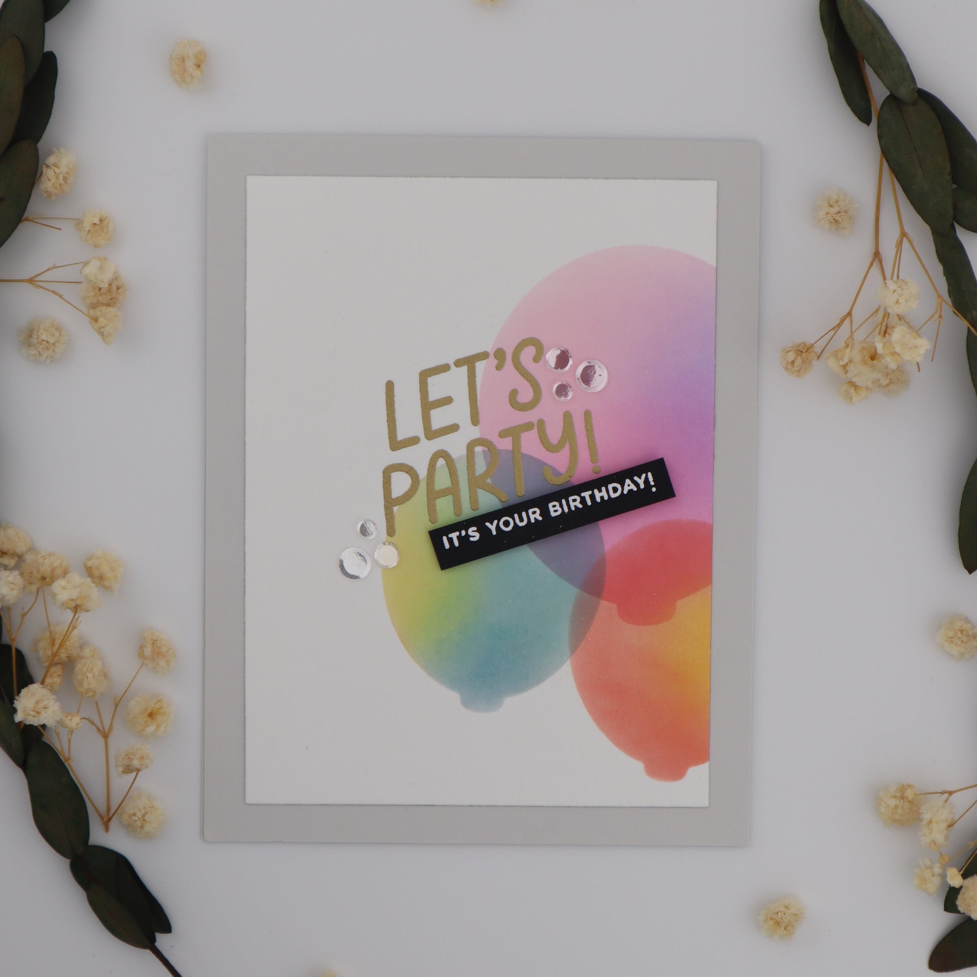 Framed poster with 'Let's Party! It's Your Birthday!' text on a white background with decorative elements.