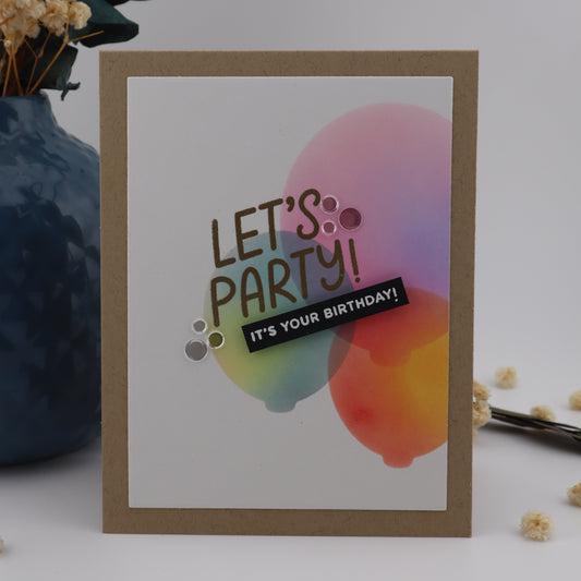 Birthday card with colorful balloons and 'Let's Party! It's Your Birthday' text on a white background with decorative elements.