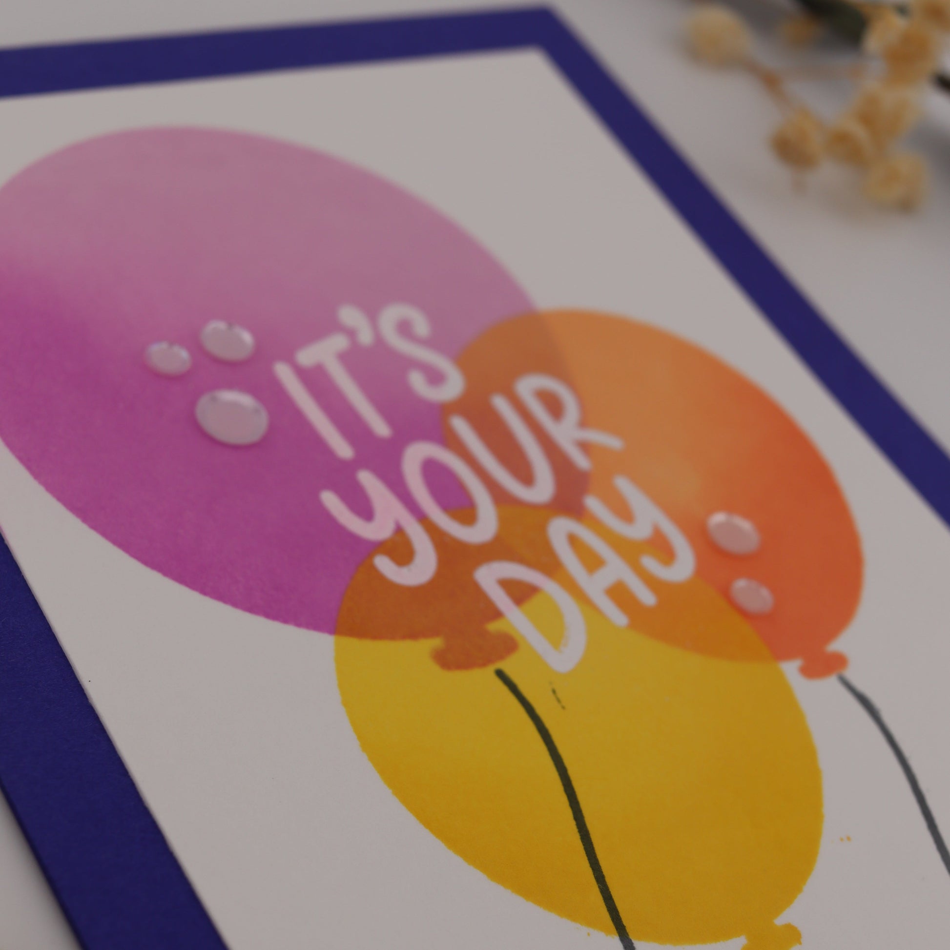 Card with 'It's Your Day' text and balloons on a white background