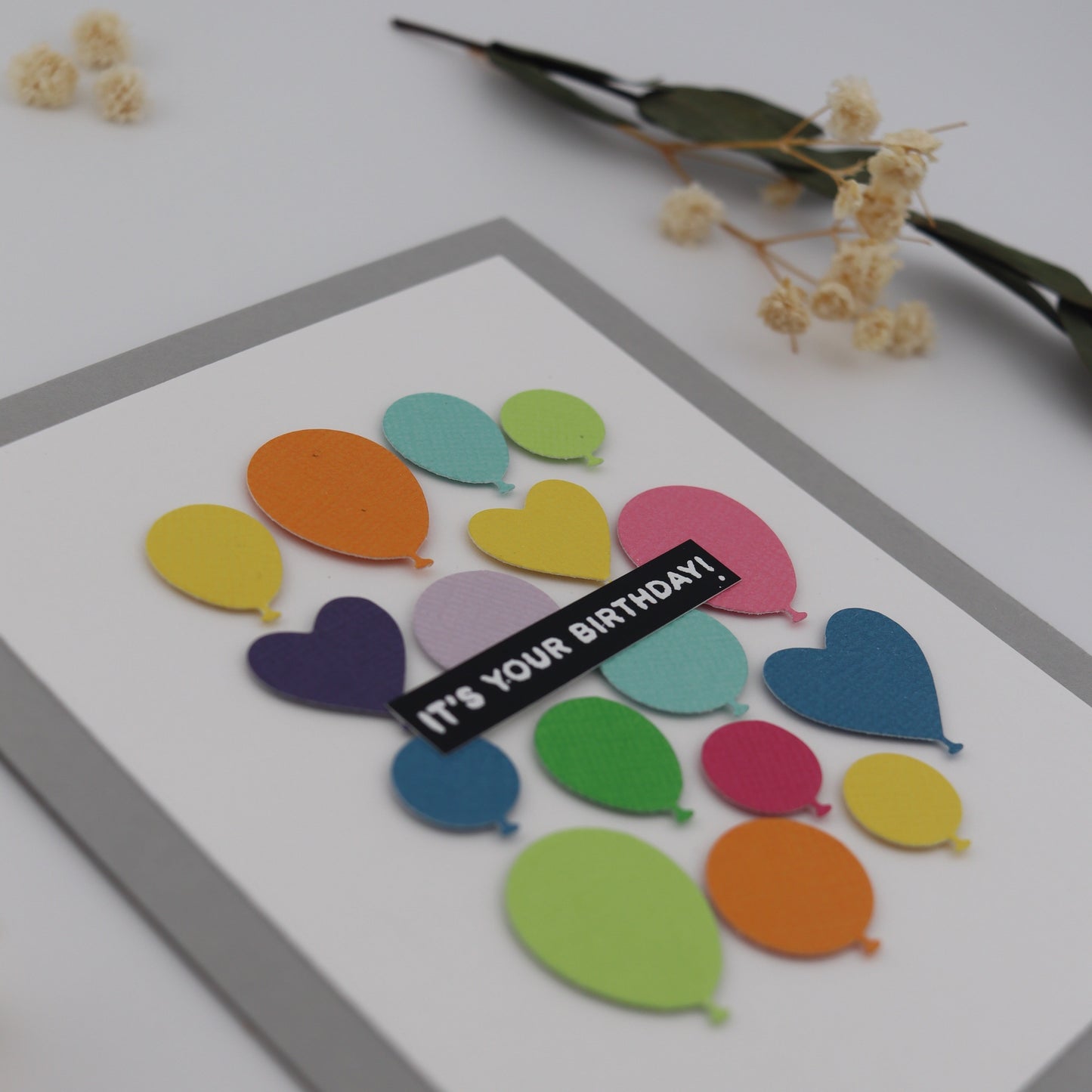 Colorful balloon-shaped card with 'It's Your Birthday!' text on a white background.