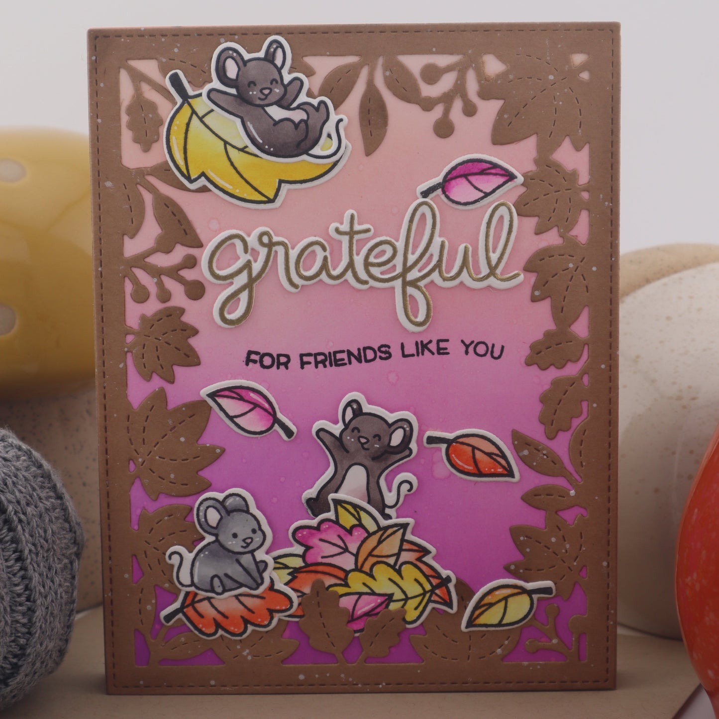 Card with colorful designs and 'grateful' text on a pink background