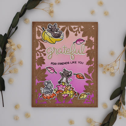 Decorative card with cartoon characters and 'grateful' text on a white background with floral elements.