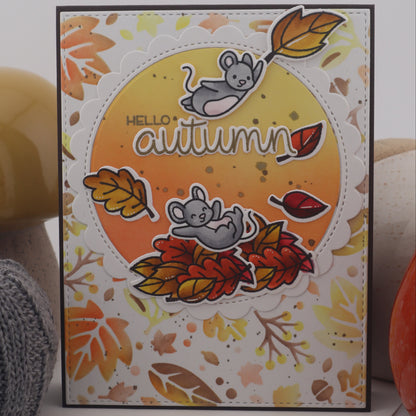 Autumn-themed card with leaves and mice design on a white surface.