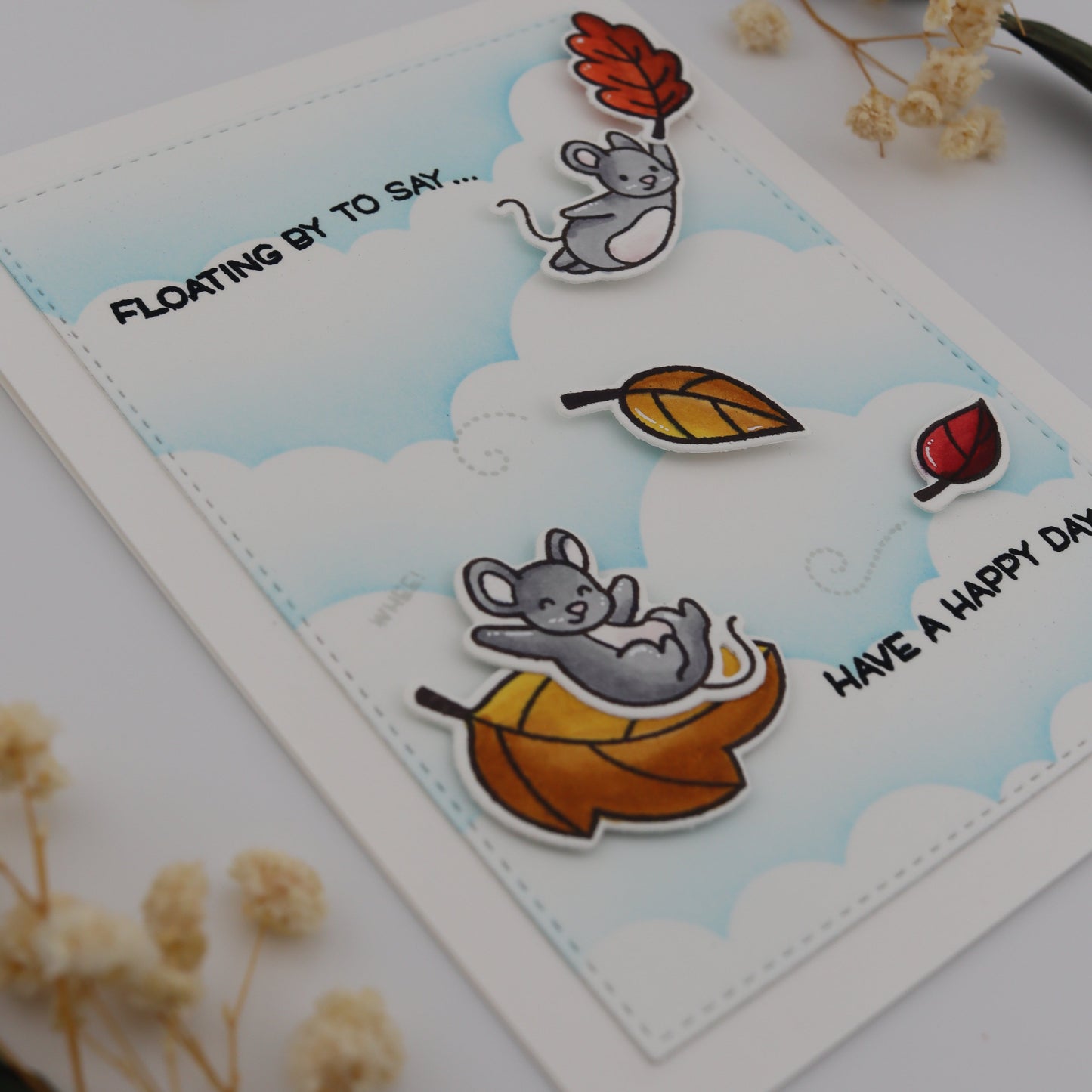 Card with cartoon mice and autumn leaves on a white background