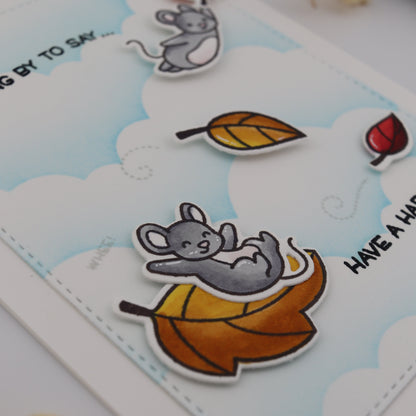 Cartoon mouse with autumn leaves on a card with 'Have a Happy Halloween' text.