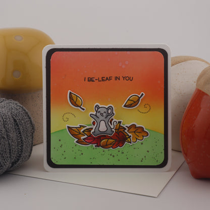 Colorful card with a bear illustration and text on a white surface