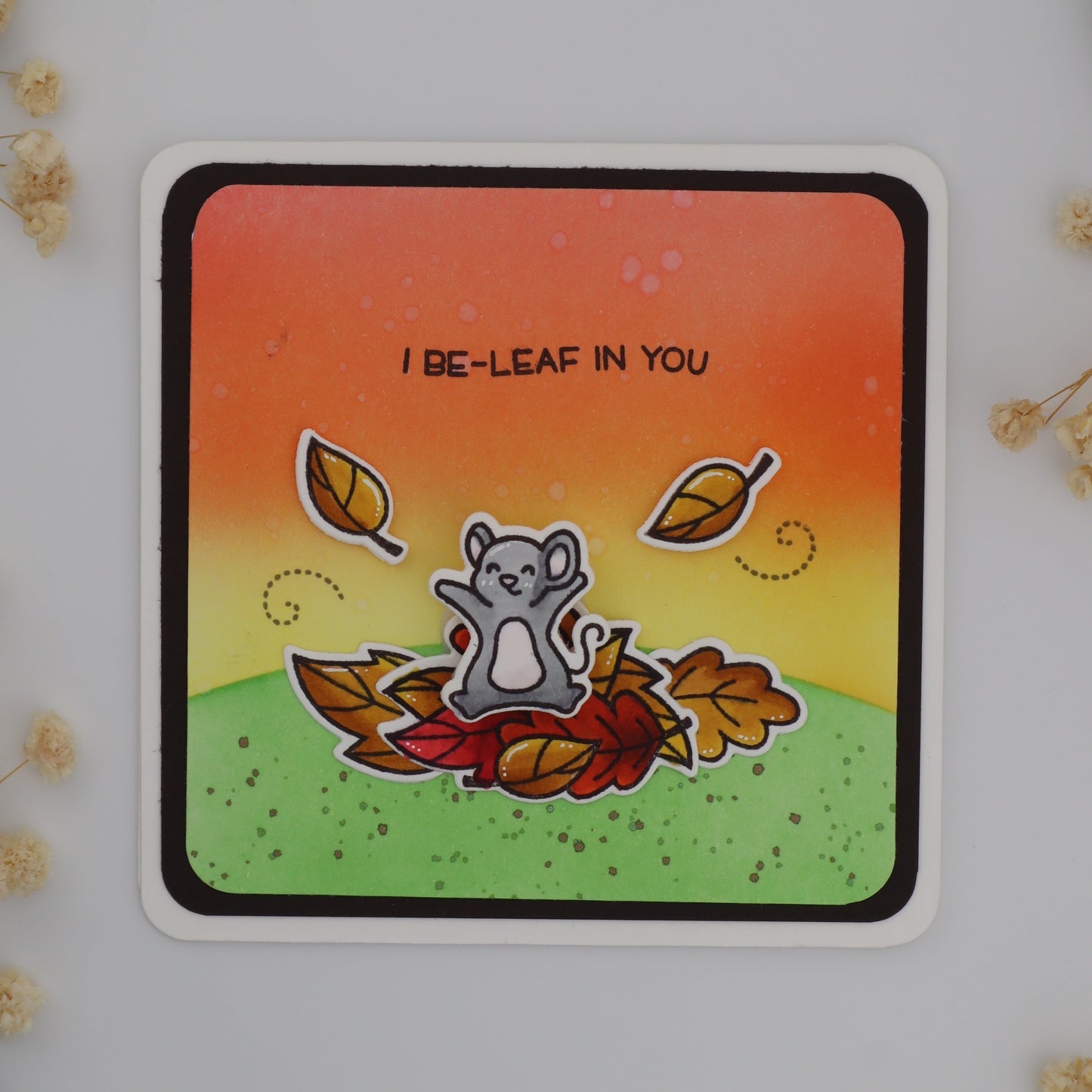 Card with a bear illustration and autumn leaves on a gradient background
