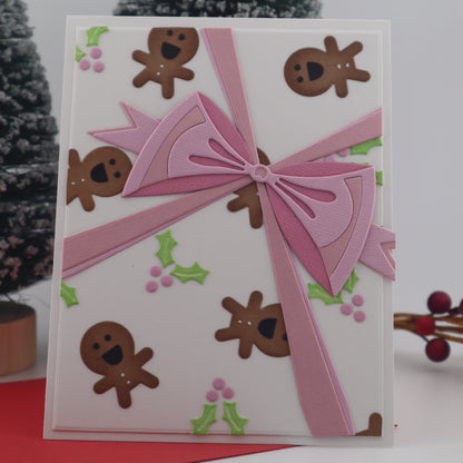 Card with pink ribbon and gingerbread men design on a white background