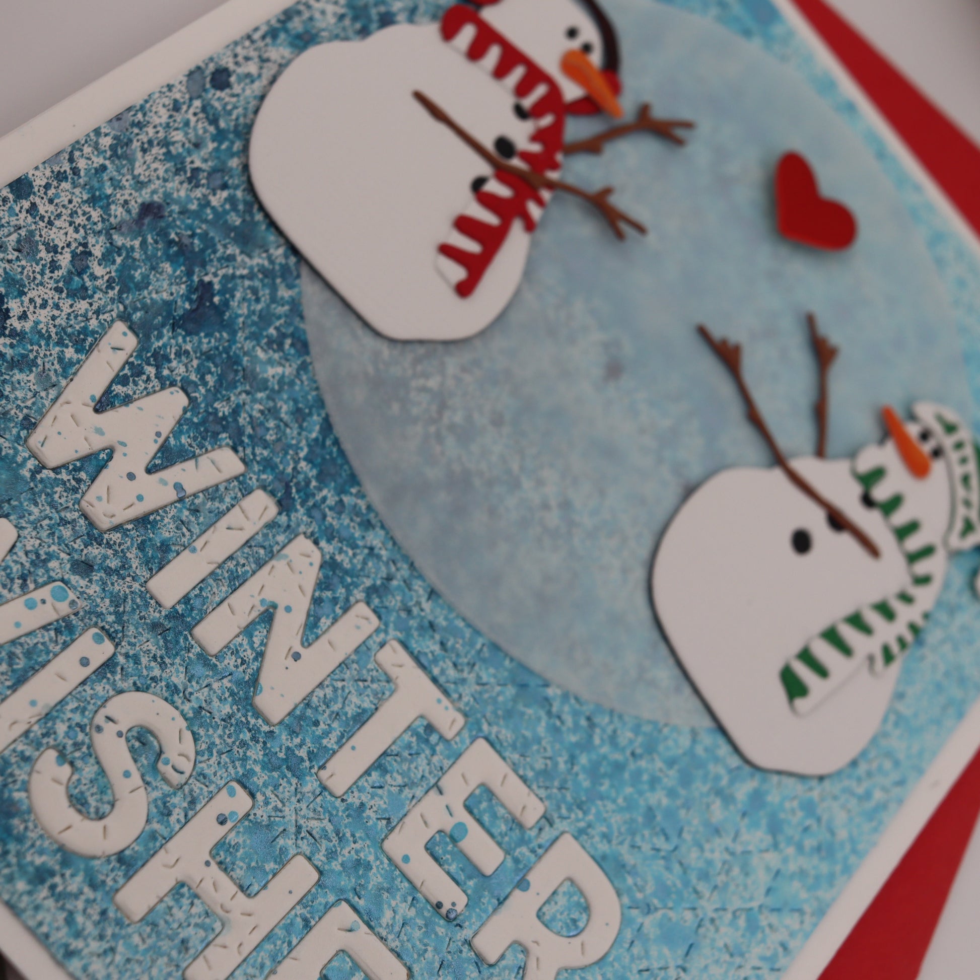 Card with snowmen and 'Winter Wishes' text on a blue background