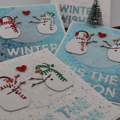 Set of winter-themed cards with snowmen and text on a gray background