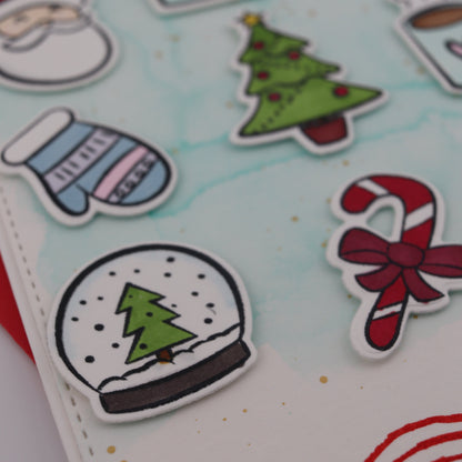 Christmas-themed stickers on a white surface with a red border
