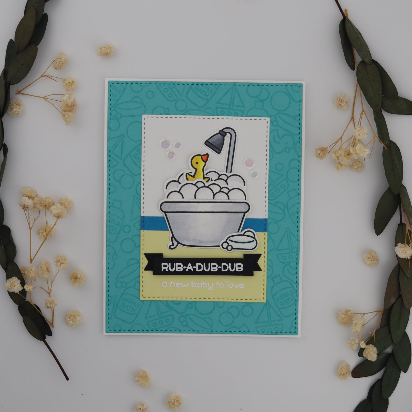 Decorative card with duck in bathtub illustration surrounded by greenery and flowers on a white background