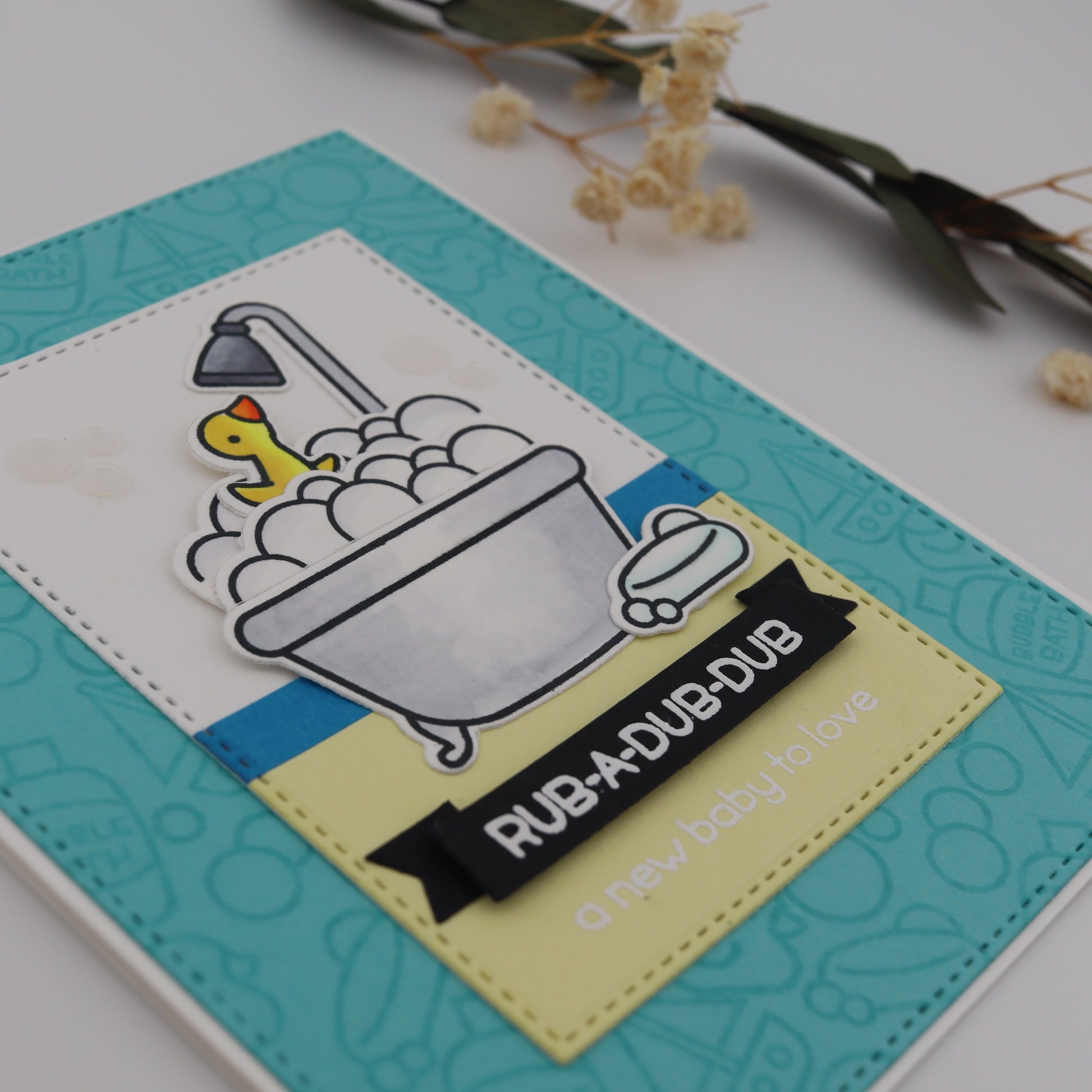 Card with a duck and bucket design and text 'Rub-a-dub-dub' on a white background.