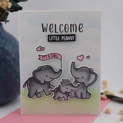 Clear stamp set with elephants and 'Welcome Little Peanut' text on a light background.