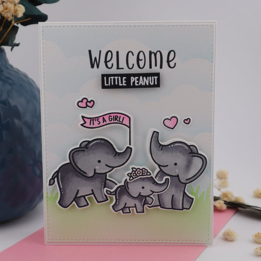 Clear stamp set with elephants and 'Welcome Little Peanut' text on a light background.