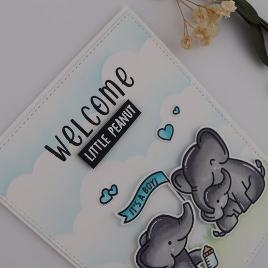 Card with two elephants and 'Welcome Little Peanut' text on a light background