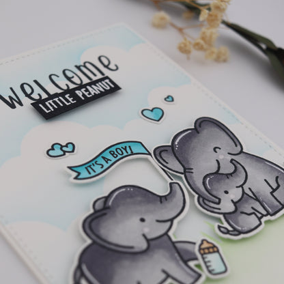 Card with elephant illustrations and 'Welcome Little Peanut It's a Boy!' text on a light background.