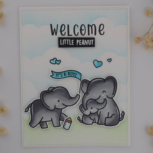 Card with two elephants and 'Welcome Little Peanut' text on a light background with flowers.