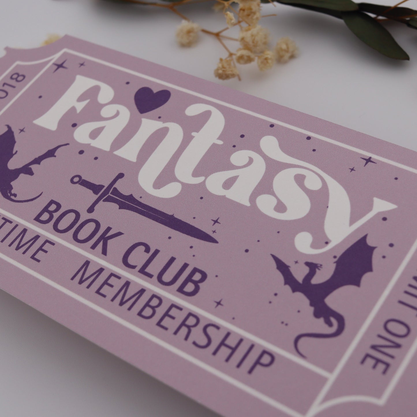 Fantasy book club membership card with decorative elements on a light background