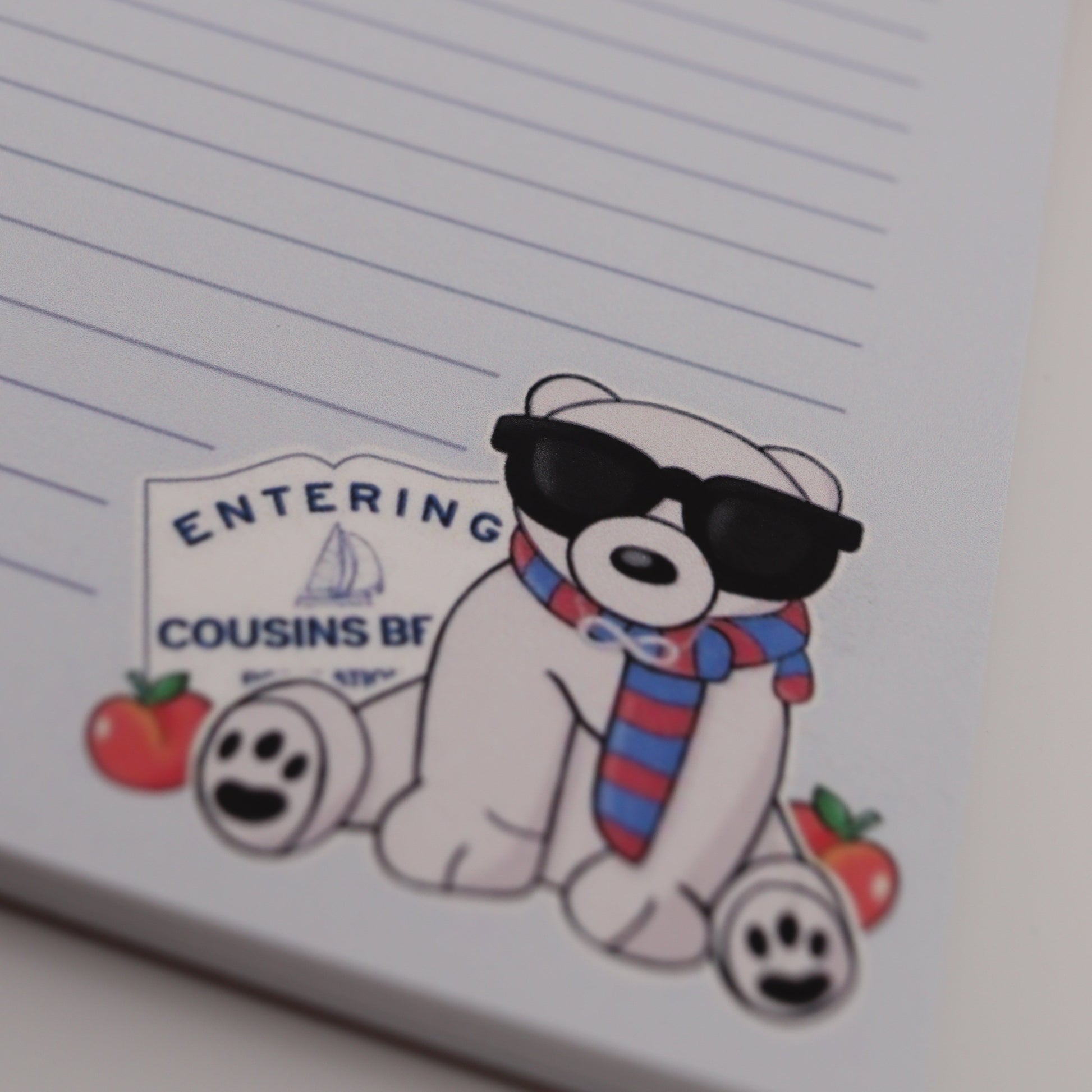 Notebook with a cartoon character sticker on a lined notebook page