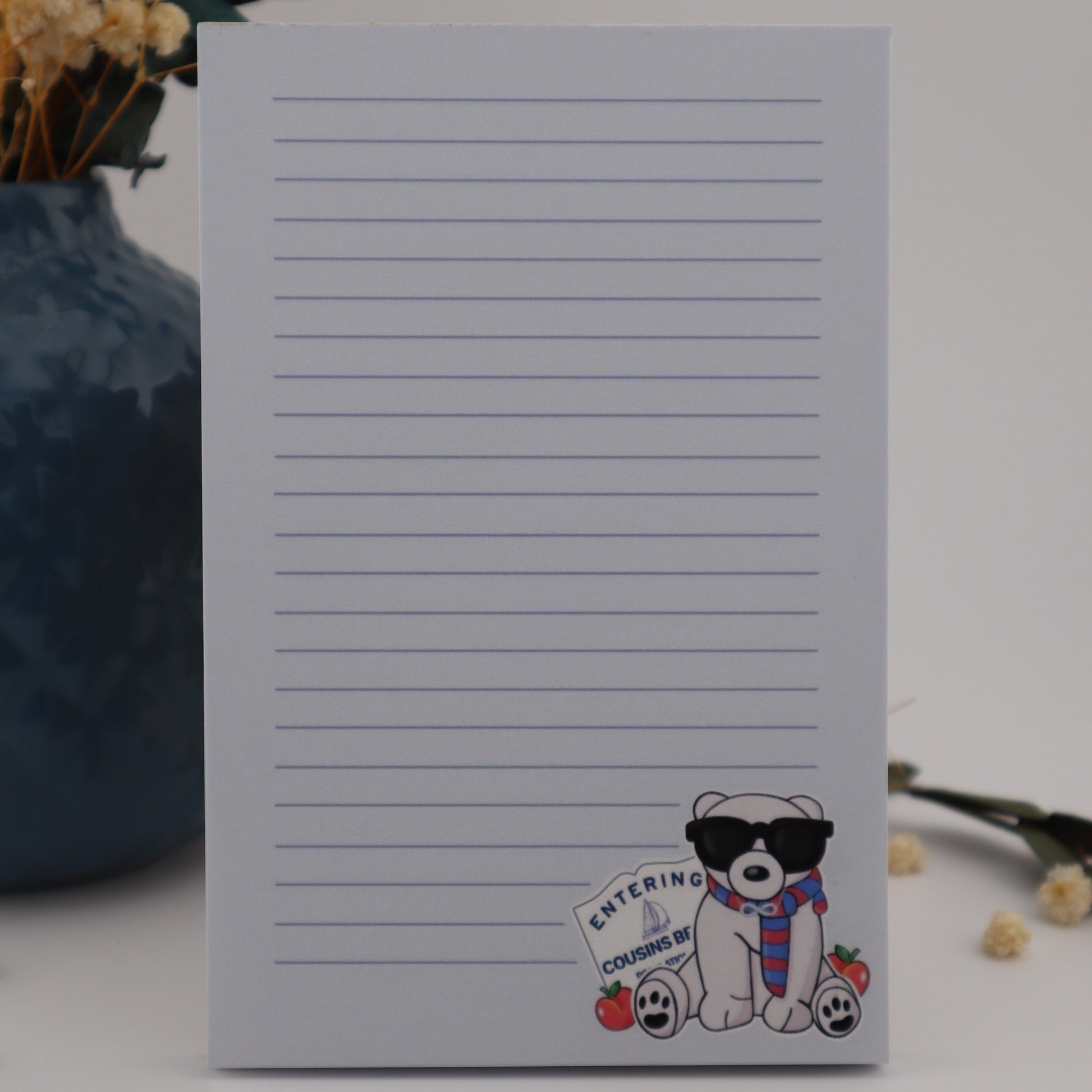 Notebook with cartoon dog design on a white surface with flowers