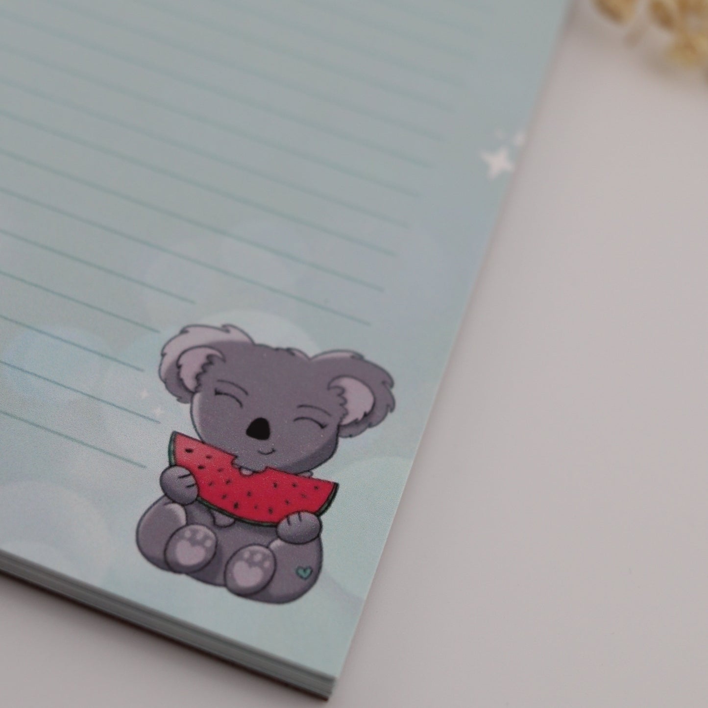 Notepad with a cartoon KOALA design on a light blue background