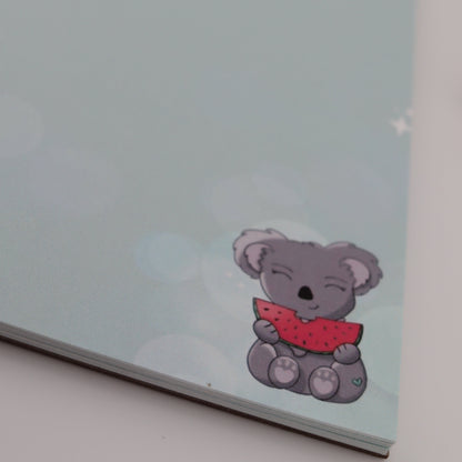 Note pad with a cartoon bear design on a light blue background