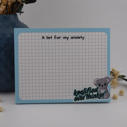 Notebook with grid paper and text, surrounded by decorative elements on a light background