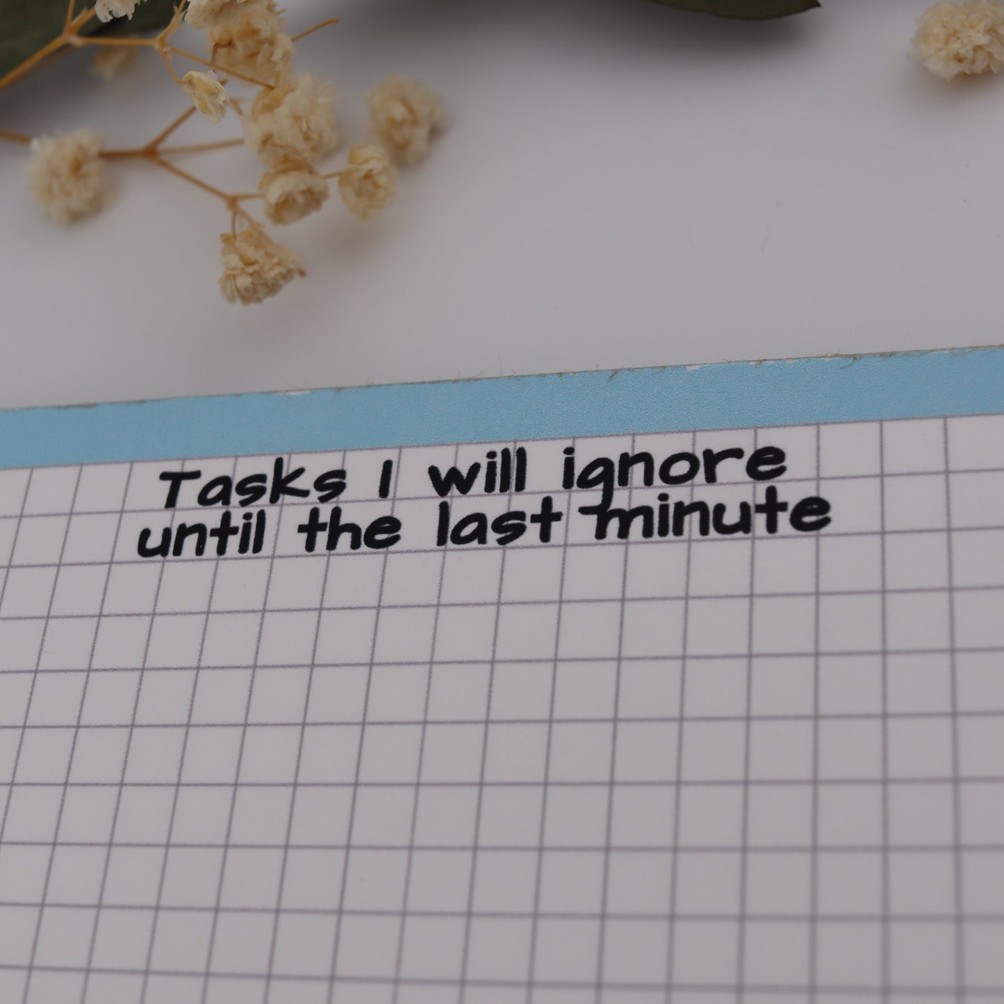 Floral arrangement on a grid paper with text and a ruler