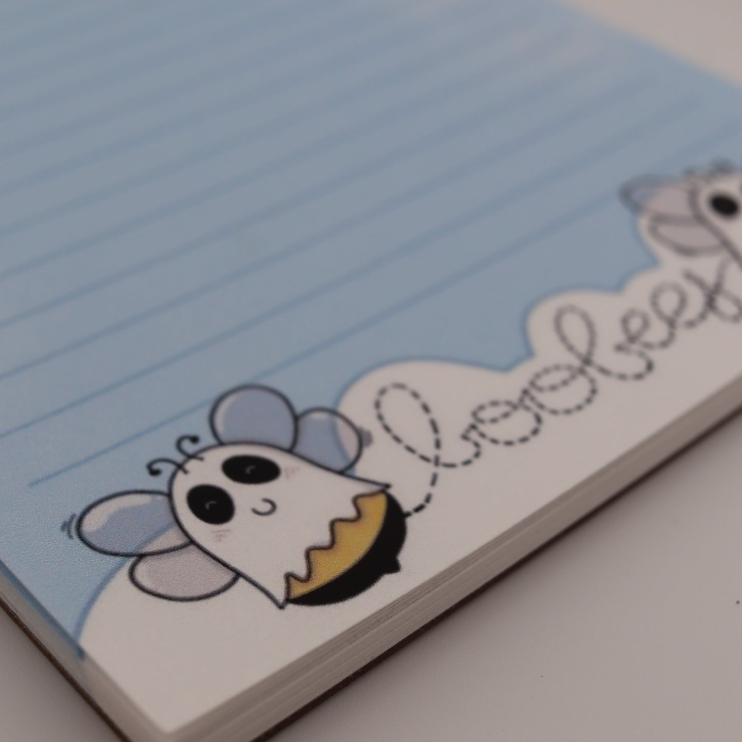 Cartoon bee design on a light blue background with text